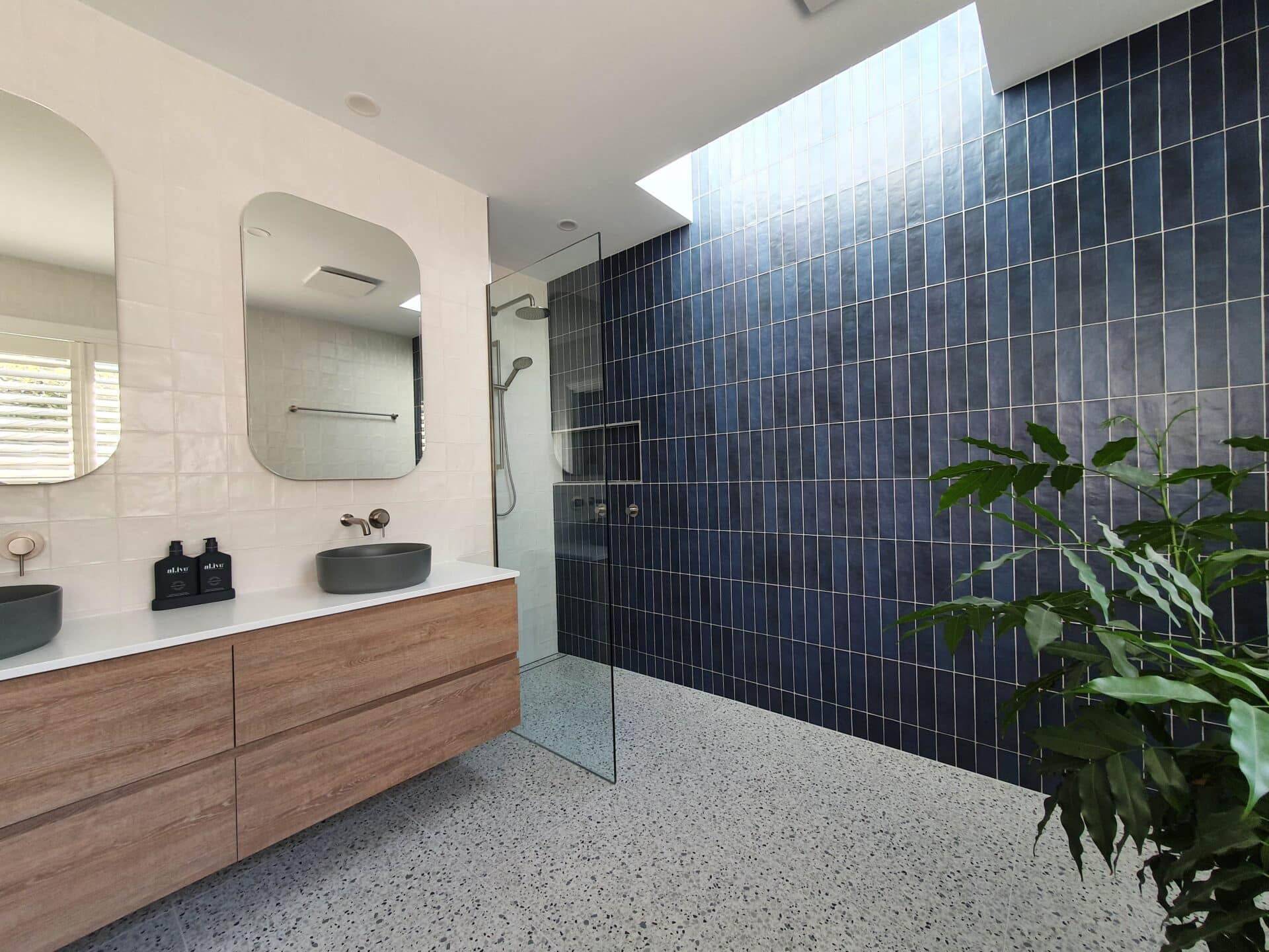 A bathroom with a large mirror and two sinks