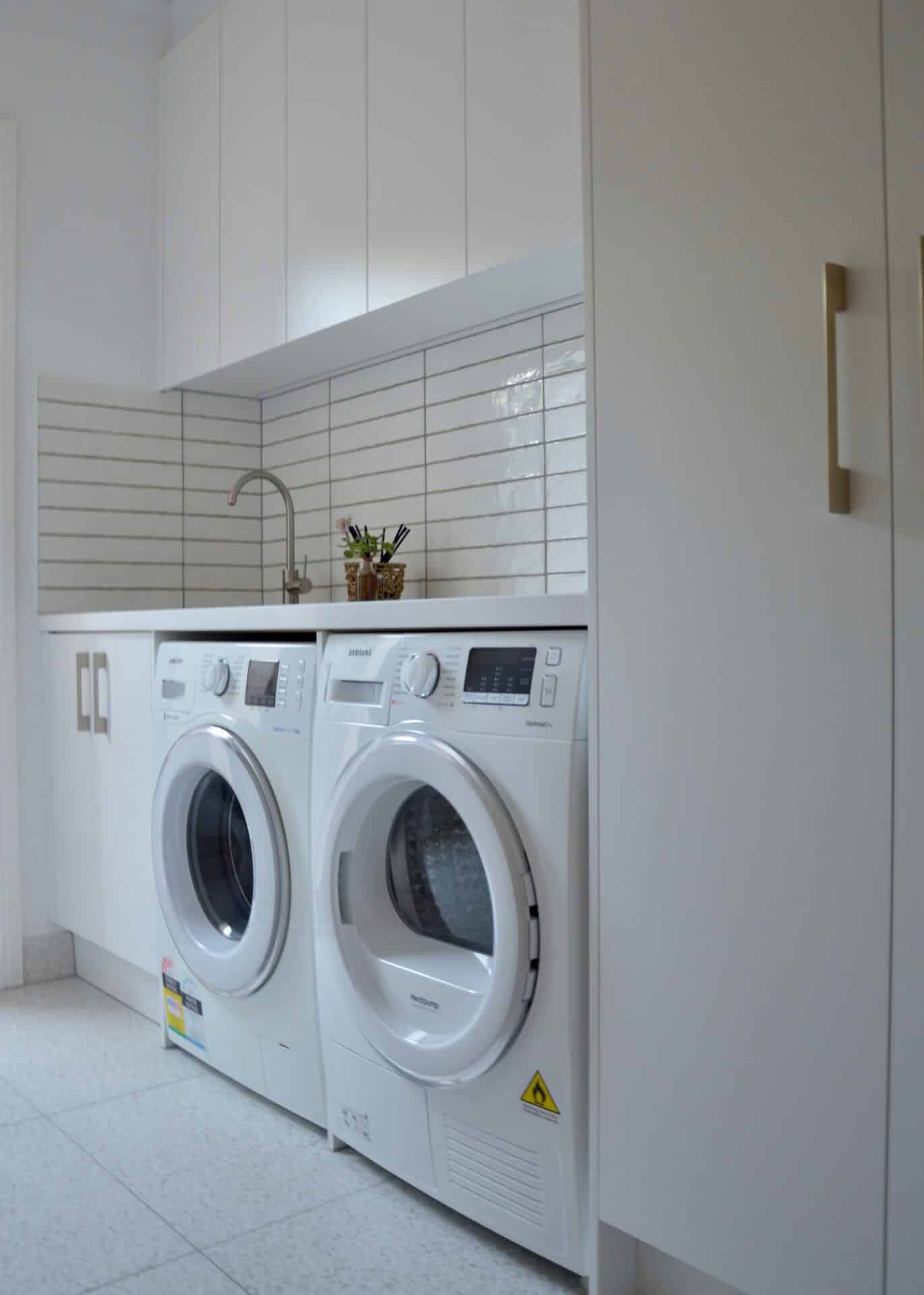 a washing machine and washer in a laundry room
