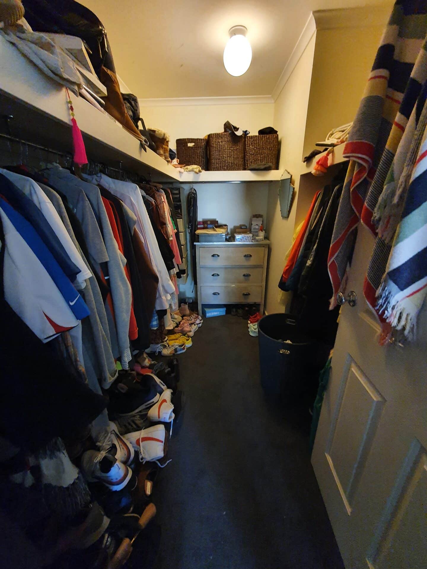 a closet with clothes on the shelves