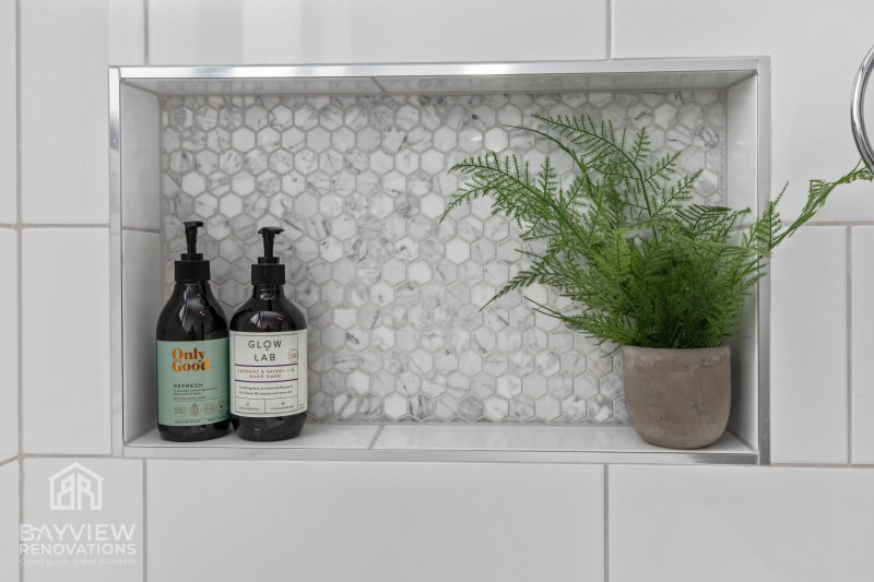 a shelf with bottles and a plant on it