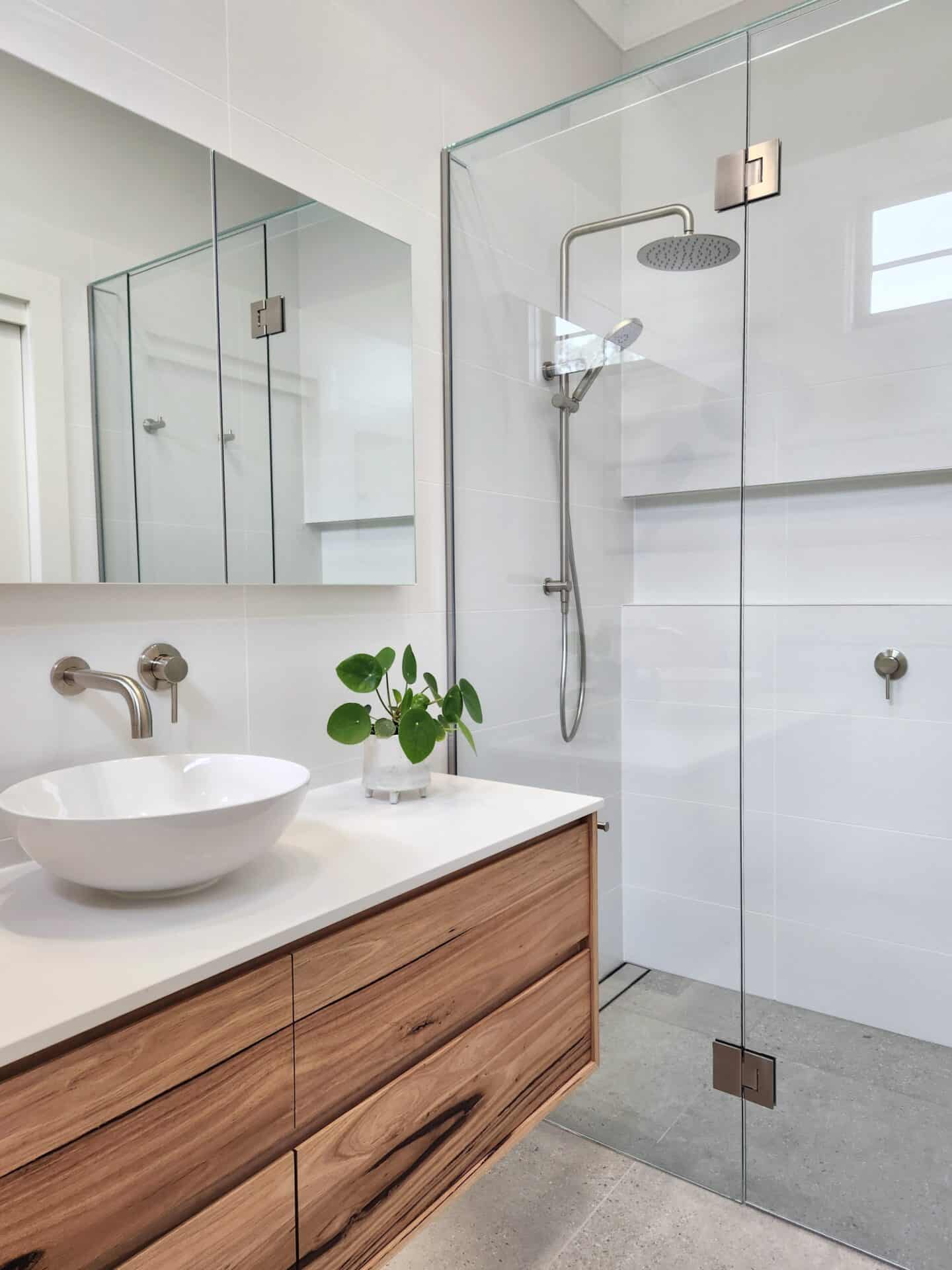 A bathroom with a sink and shower.