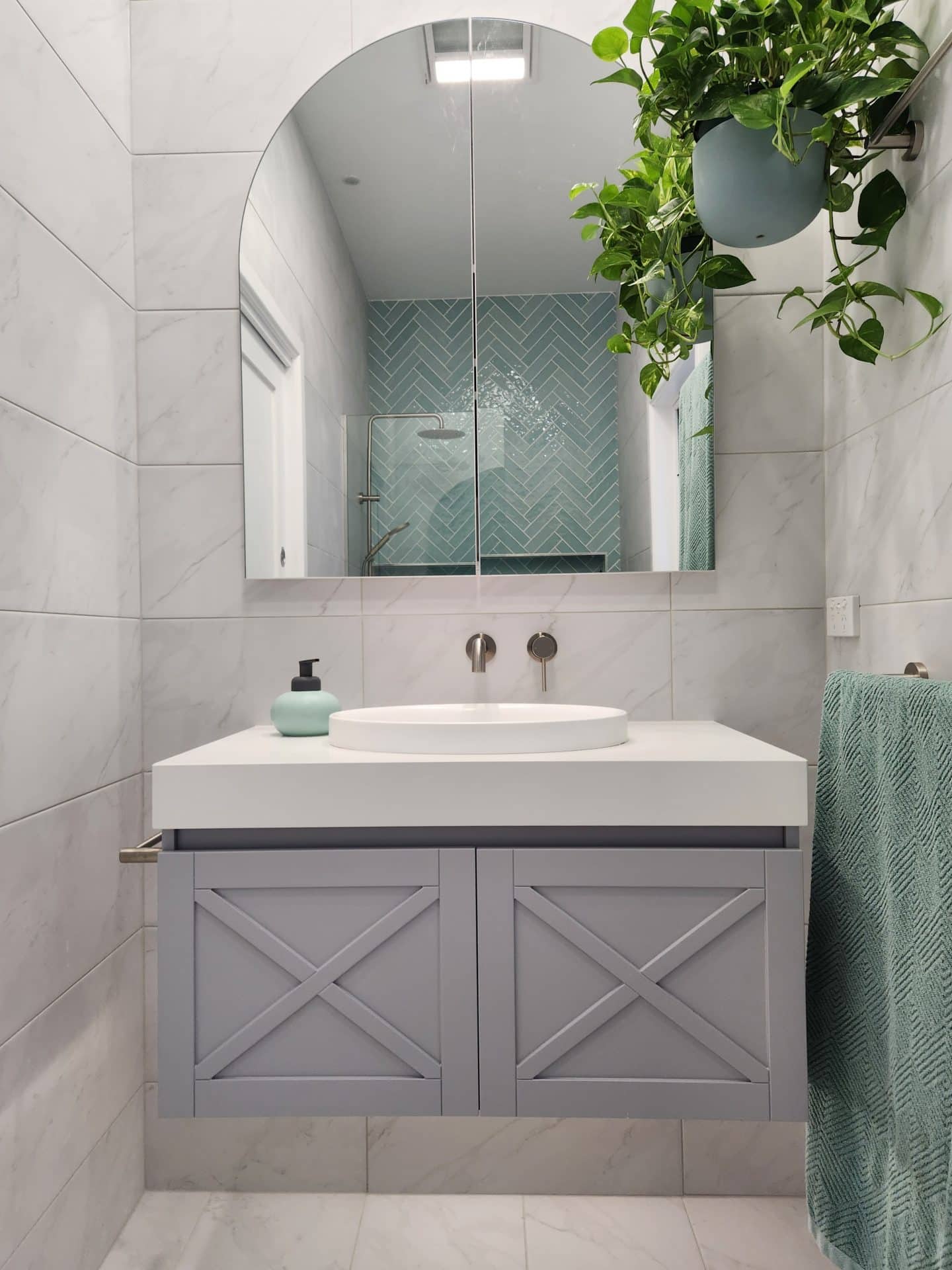 A Parkdale ensuite with a blue and white tiled wall on Bethell Avenue.