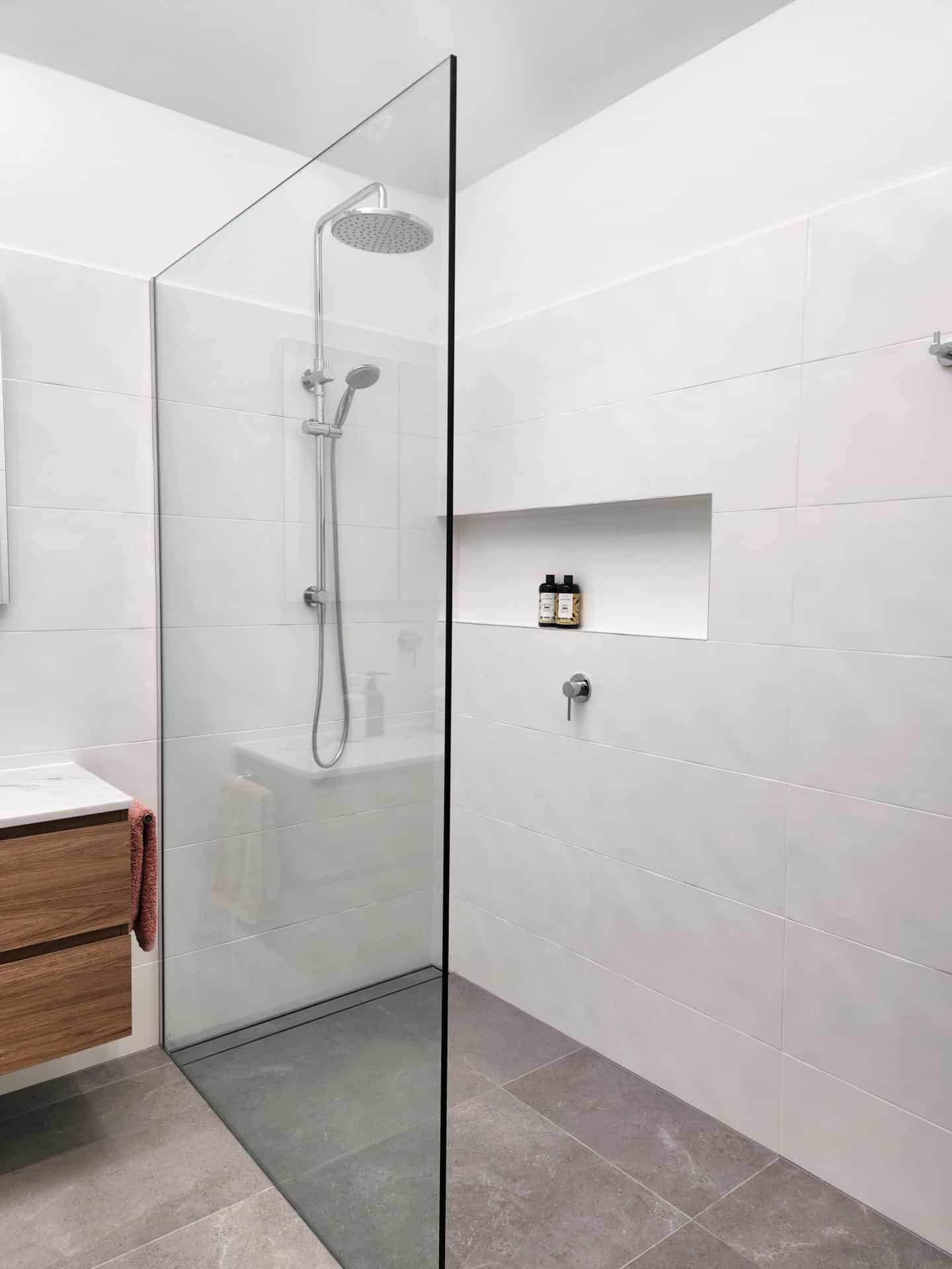 a modern bathroom with a glass shower stall.