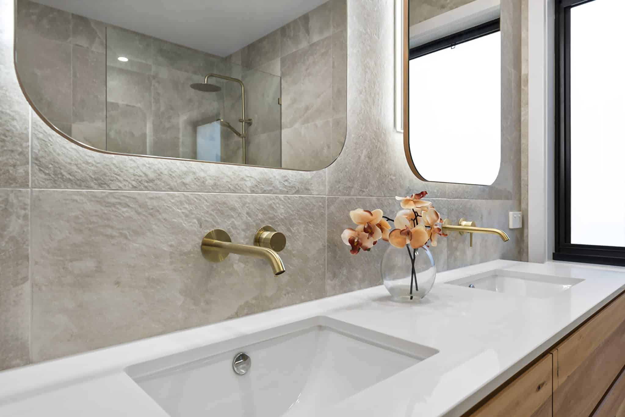bathroom renovation beaumaris showing sinks, tapware, mirrors, cabinet, lighting